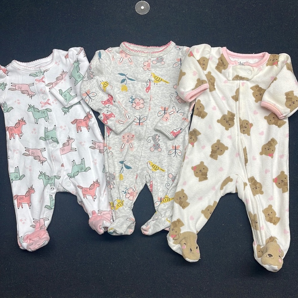 Bundle 3 sleepers size newborn. 2 are Child of Mine 1 is Carters.